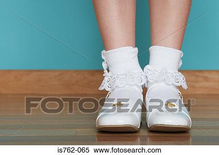 Stock Photography - Girl wearing white shoes. Fotosearch