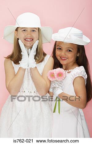Stock Image - Two girls with a bunch of flowers. Fotosearch