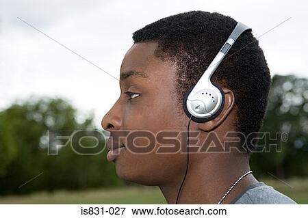 Stock Photo - Boy listening to music. Fotosearch