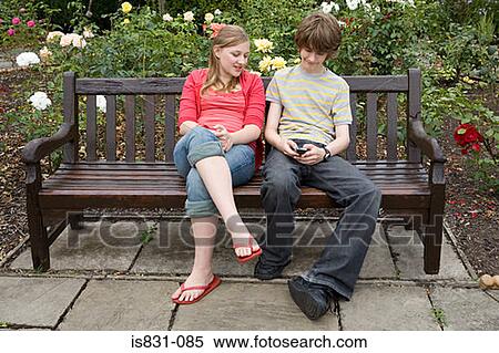 Stock Photography - Girl and boy with cellphone. Fotosearch