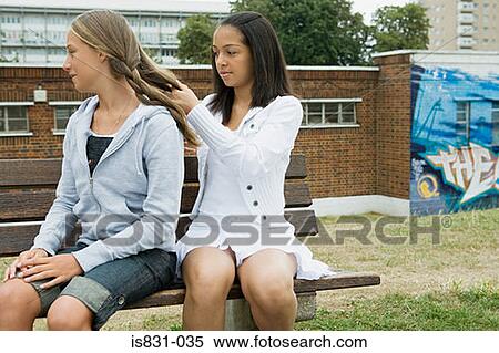 Girl playing plaiting friends hair View Large Photo Image Stock Photography - Girl playing plaiting friends hair. Fotosearch