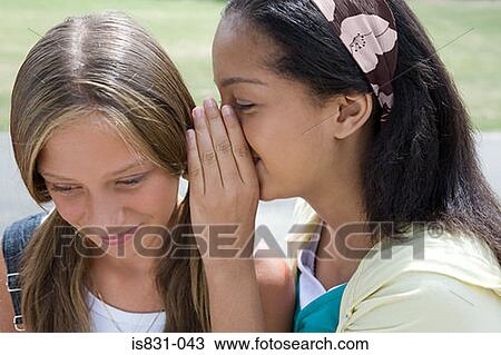 Stock Image - Girls whispering. Fotosearch