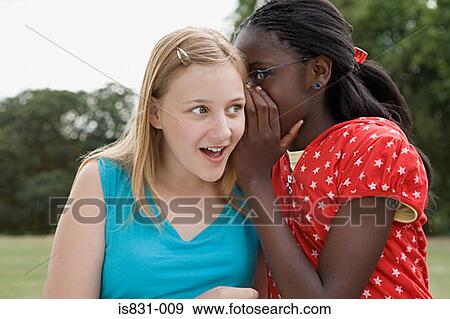 Stock Photo - Girls whispering. Fotosearch