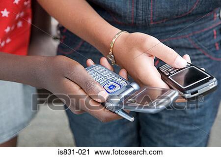 Girls with cellphones View Large Photo Image Stock Image - Girls with cellphones. Fotosearch