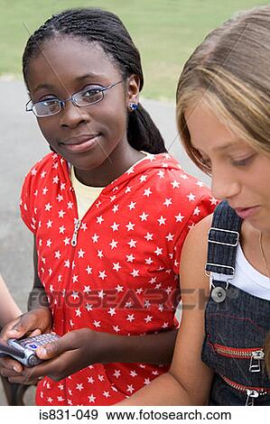 Stock Photo - Girls with cellphones. Fotosearch