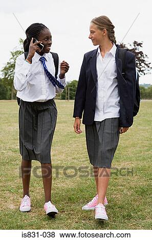 Schoolgirls walking with cellphone View Large Photo Image Stock Photo - Schoolgirls walking with cellphone. Fotosearch