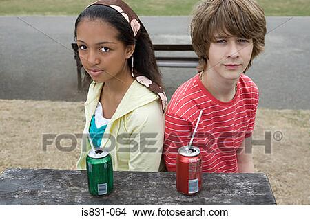 Teenage boy and girl with drinks View Large Photo Image Picture - Teenage boy and girl with drinks. Fotosearch