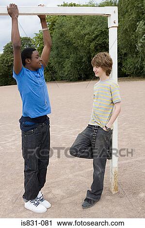Stock Image - Teenage boys by goalpost. Fotosearch