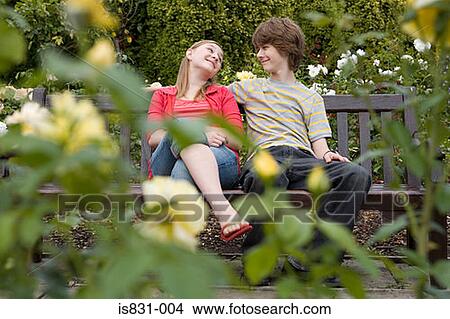 Teenage couple on a park bench View Large Photo Image Picture - Teenage couple on a park bench. Fotosearch