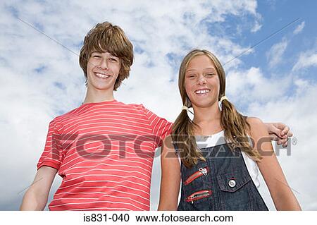 Stock Image - Teenage couple smiling. Fotosearch