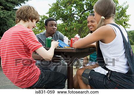 Teenage friends having lunch View Large Photo Image Stock Photo - Teenage friends having lunch. Fotosearch