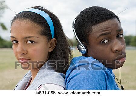 Stock Photograph - Teenage girl and boy back to back. Fotosearch