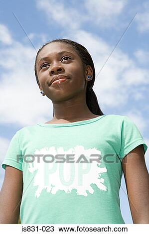 Stock Image - Teenage girl looking up. Fotosearch