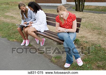 Teenage girls on a bench View Large Photo Image Stock Photography - Teenage girls on a bench. Fotosearch