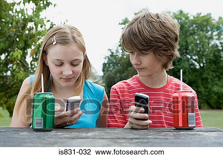 Stock Image - Teenagers with cellphones. Fotosearch