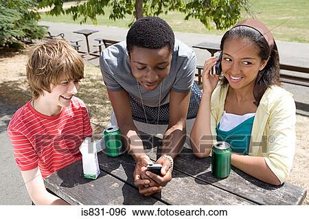 Teenagers with drinks and cellphones View Large Photo Image Stock Photograph - Teenagers with drinks and cellphones. Fotosearch
