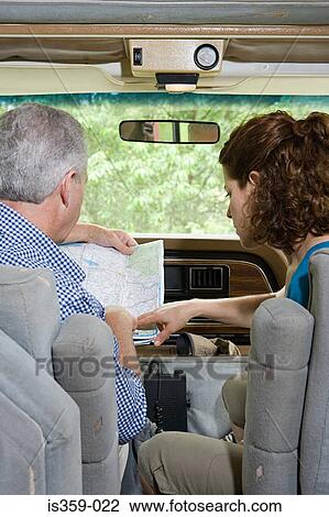 Couple planning trip with a map in caravan View Large Photo Image Stock Image - Couple planning trip with a map in caravan. Fotosearch