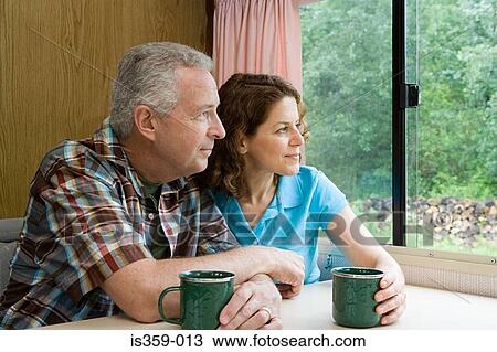 Couple relaxing in caravan View Large Photo Image Stock Image - Couple relaxing in caravan. Fotosearch