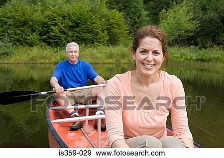 Mature couple canoeing View Large Photo Image Stock Photo - Mature couple canoeing. Fotosearch