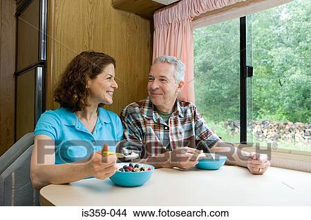 Picture - Mature couple eating breakfast. Fotosearch