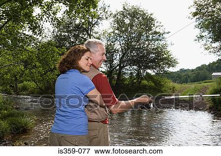 Mature couple fishing in stream View Large Photo Image Stock Photo - Mature couple fishing in stream. Fotosearch