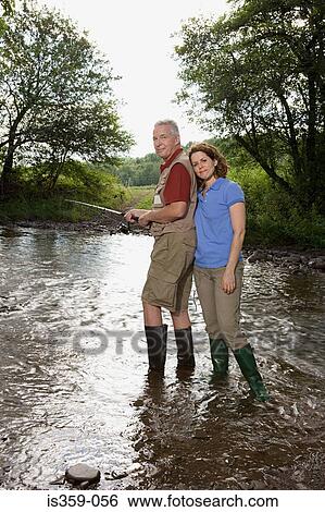 Mature couple fishing in stream View Large Photo Image Stock Photograph - Mature couple fishing in stream. Fotosearch