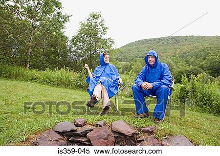 Mature couple wearing raincoats View Large Photo Image Stock Photography - Mature couple wearing raincoats. Fotosearch