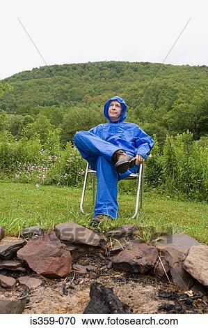 Mature man wearing a blue raincoat View Large Photo Image Stock Image - Mature man wearing a blue raincoat. Fotosearch