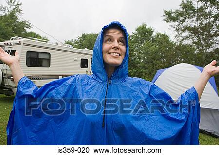 Woman wearing a blue plastic raincoat View Large Photo Image Stock Image - Woman wearing a blue plastic raincoat. Fotosearch
