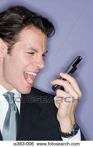 Stock Photograph - Businessman shouting into cellphone. Fotosearch