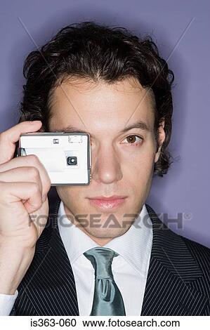 Stock Image - Businessman taking a photograph. Fotosearch