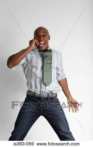 Stock Photo - Happy man on cellphone. Fotosearch