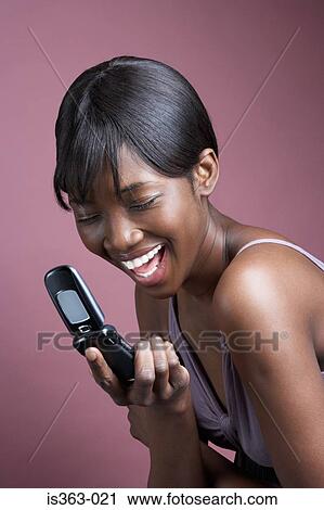 Stock Image - Happy woman with cellphone. Fotosearch