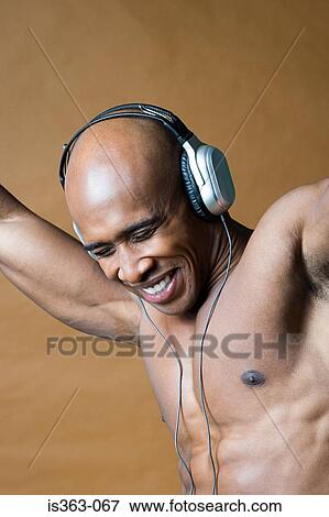 Joyful man wearing headphones View Large Photo Image Stock Photo - Joyful man wearing headphones. Fotosearch
