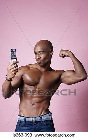 Man flexing his muscles for camera View Large Photo Image Stock Image - Man flexing his muscles for camera. Fotosearch