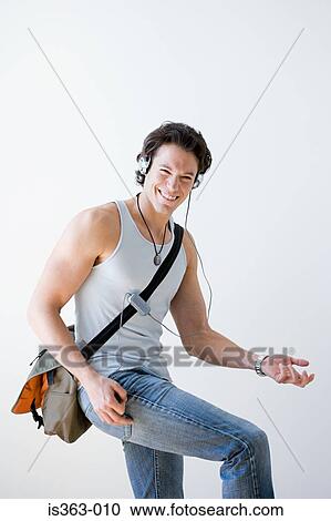 Stock Image - Man playing air guitar. Fotosearch