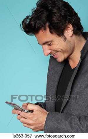 Stock Photo - Man using cellphone. Fotosearch
