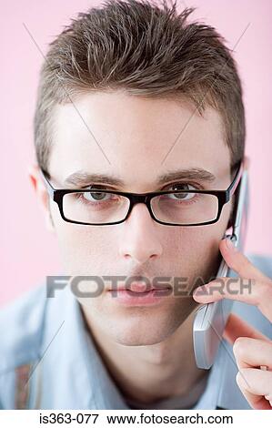 Serious man on cellphone View Large Photo Image Stock Photo - Serious man on cellphone. Fotosearch