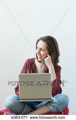Thoughtful woman with laptop View Large Photo Image Stock Image - Thoughtful woman with laptop. Fotosearch