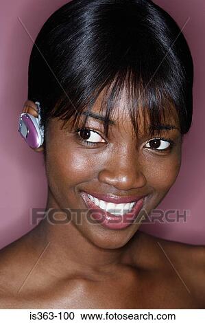 Stock Image - Woman with handsfree headset. Fotosearch