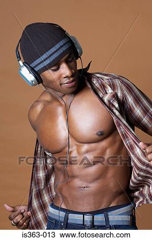 Young man baring his chest View Large Photo Image Stock Image - Young man baring his chest. Fotosearch