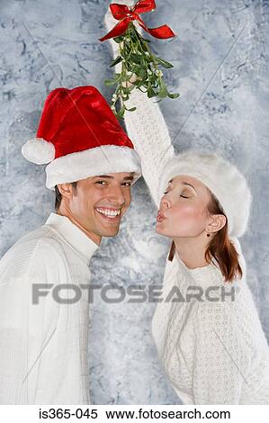 Couple under mistletoe View Large Photo Image Stock Photography - Couple under mistletoe. Fotosearch