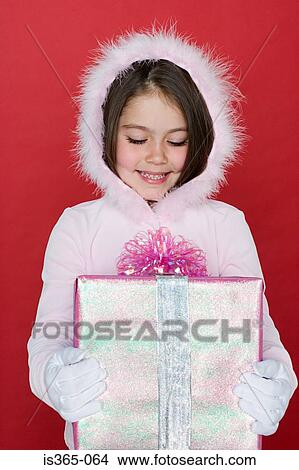 Girl holding present View Large Photo Image Picture - Girl holding present. Fotosearch