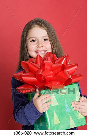 Girl holding present View Large Photo Image Stock Image - Girl holding present. Fotosearch