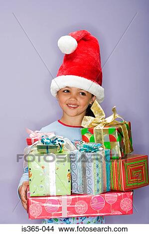 Girl holding presents View Large Photo Image Picture - Girl holding presents. Fotosearch