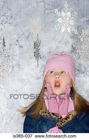 Girl looking at snowflakes View Large Photo Image Stock Photo - Girl looking at snowflakes. Fotosearch