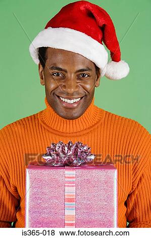 Stock Photo - Man holding present. Fotosearch