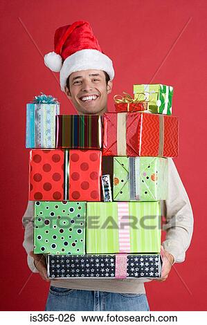 Man holding presents View Large Photo Image Stock Photograph - Man holding presents. Fotosearch