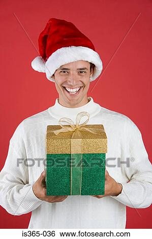 Man holding presents View Large Photo Image Stock Photograph - Man holding presents. Fotosearch