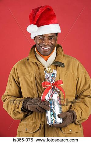 Man holding wrapped champagne bottle View Large Photo Image Stock Photography - Man holding wrapped champagne bottle. Fotosearch